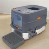 A modern, enclosed cat litter box with a stainless steel base and a gray plastic top, shown on a wooden floor. Náhľad obrázku produktu