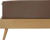 A close-up view of a bed frame with a brown fitted sheet. Produktbild-Vorschau