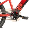 A close-up view of the crankset and chain guard of a red bicycle. Produktbild-Vorschau