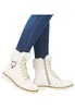 A pair of white fur-lined lace-up boots worn with blue jeans. Produktbild-Vorschau