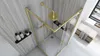 A modern bathroom with a gold-framed shower enclosure. Podgląd zdjęcia produktu