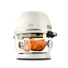 A rotisserie chicken is shown inside a glass air fryer. Voir les images du produit