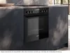 A modern kitchen scene featuring a built-in oven and stovetop. Produktbild-Vorschau