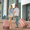 A couple with luggage outside a modern building. Náhľad obrázku produktu