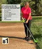A woman is using a cordless garden tool in a yard. Produktbild-Vorschau