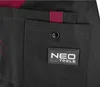 A close-up of a black work overall with a maroon accent and a logo patch. Anteprima dell’immagine prodotto