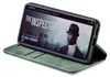 A smartphone in a green flip case is displayed on a white background, showing a movie poster on its screen. Produktbild-Vorschau