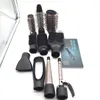 A collection of hair styling attachments and a manual are laid out on a white background. Anteprima dell’immagine prodotto