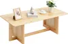 A wooden coffee table with decorative items on top. Produktbild-Vorschau