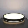 A round, black-rimmed LED ceiling light is shown on a dark surface. Náhľad obrázku produktu