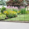 A black metal garden fence is shown in front of a garden with various flowers and greenery. Produktbild-Vorschau