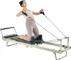 A woman is using a Pilates reformer machine. Voir les images du produit