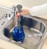 A person is using a plunger in a kitchen sink. Produktbild-Vorschau