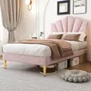 A pink upholstered bed with a shell-shaped headboard is shown in a bedroom setting. Produktbild-Vorschau