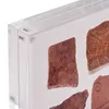 A close-up view of a clear acrylic frame holding fragments of pottery. Produktbild-Vorschau