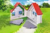 A toy house with red roofs and white walls, set in a grassy outdoor scene with trees and buildings in the background. Produktbild-Vorschau