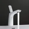 A white faucet with water running from it, set against a dark background. Produktbild-Vorschau
