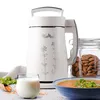 A white soy milk maker is displayed with ingredients and finished products such as milk, almonds, and soup. Produktbild-Vorschau