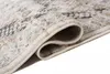 A close-up view of a rolled-up rug, showing its texture and intricate pattern. Náhled obrázku produktu