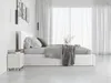 A modern bedroom with a white bed and grey bedding, large sheer curtains in the background, and a white nightstand on the left. Produktbild-Vorschau