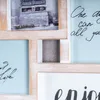 A collage of photos and text in a wooden frame. Produktbild-Vorschau