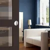 A modern living room with a blue wall, white sofa, and a lamp. Produktbild-Vorschau