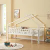 A child's house bed in a room with yellow walls and a window. Produktbild-Vorschau