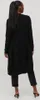 A woman wearing a black cardigan and pants, viewed from the back. Produktbild-Vorschau