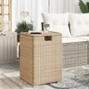 A beige rattan propane tank cover is placed on a patio next to a sofa. Produktbild-Vorschau