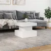 A modern living room scene with a gray sectional sofa, a white coffee table, and a potted plant. Voir les images du produit
