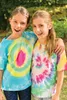Two young girls are posing for a photo outdoors, wearing tie-dye t-shirts. Produktbild-Vorschau