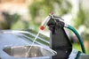 A garden hose nozzle spraying water into a sink. Náhled obrázku produktu