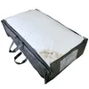 A white duvet or pillow in a dark gray storage bag with handles. Produktbild-Vorschau