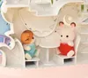 Two baby animal figures are sitting in a toy playset. Podgląd zdjęcia produktu