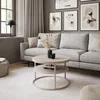A modern living room with a couch, coffee table, and artwork. Náhľad obrázku produktu