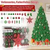 A Christmas tree decorated with ornaments and a star topper, with a box of ornaments in the foreground. Produktbild-Vorschau