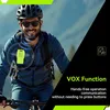 A man riding a bicycle, wearing a helmet and sunglasses, with a bright yellow walkie-talkie attached to his chest. Produktbild-Vorschau