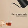 A hand is holding a glass mug filled with tea, while water is being poured into it from a black gooseneck kettle. The image highlights the kettle's water outlet feature. Náhled obrázku produktu