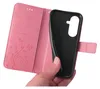A hand holding a pink flip phone case with a floral design, revealing the black inner shell for a phone. Produktbild-Vorschau