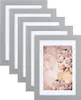 A stack of silver picture frames with one frame displaying a portrait of a woman adorned with flowers. Produktbild-Vorschau