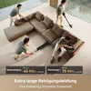 Multiple people are shown using a cordless vacuum cleaner to clean a large sectional sofa in a modern living room. Produktbild-Vorschau