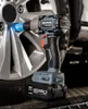 An impact wrench is shown being used to tighten a lug nut on a car wheel. Podgląd zdjęcia produktu