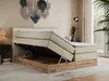 A bedroom scene with a bed that has its storage compartment open. Produktbild-Vorschau