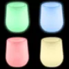 Four illuminated planters in different colors against a black background. Produktbild-Vorschau