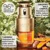 A Clarins Double Serum Eye product bottle is shown in a natural setting with flowers and turmeric roots. Anteprima dell’immagine prodotto