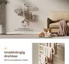 A white electric towel warmer with towels is shown in a modern living room setting with a couch and a dog. Produktbild-Vorschau