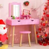 A pink children's vanity desk and stool set is decorated for Christmas with a pink Christmas tree, ornaments, and a Santa figure. Produktbild-Vorschau