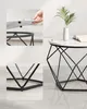 A white marble-effect coffee table with a black geometric metal frame, styled with a white vase containing a green plant and a book. Náhled obrázku produktu