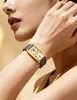 A woman wearing a gold rectangular watch with a gray strap. Podgląd zdjęcia produktu