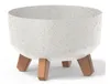 A white speckled planter with three brown legs, shown against a white background. Náhled obrázku produktu